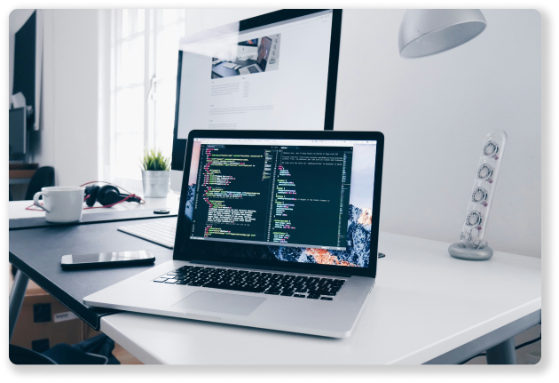 laptop sitting on a desk showing website development code